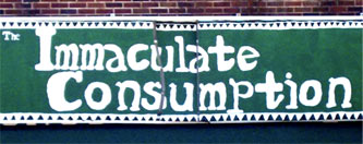 Immaculate Consumption painted on a green background on a brick wall
