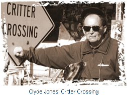 Clyde Jones sitting next to his Critter Crossing sign