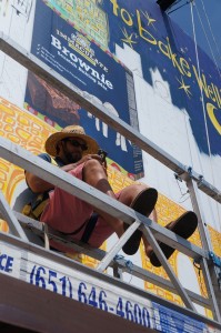 Artist Any on window washing platform for a billboard